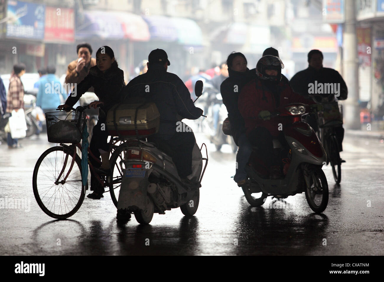 Shanghai, silhouette of bicycle and motorcycle riders Stock Photo