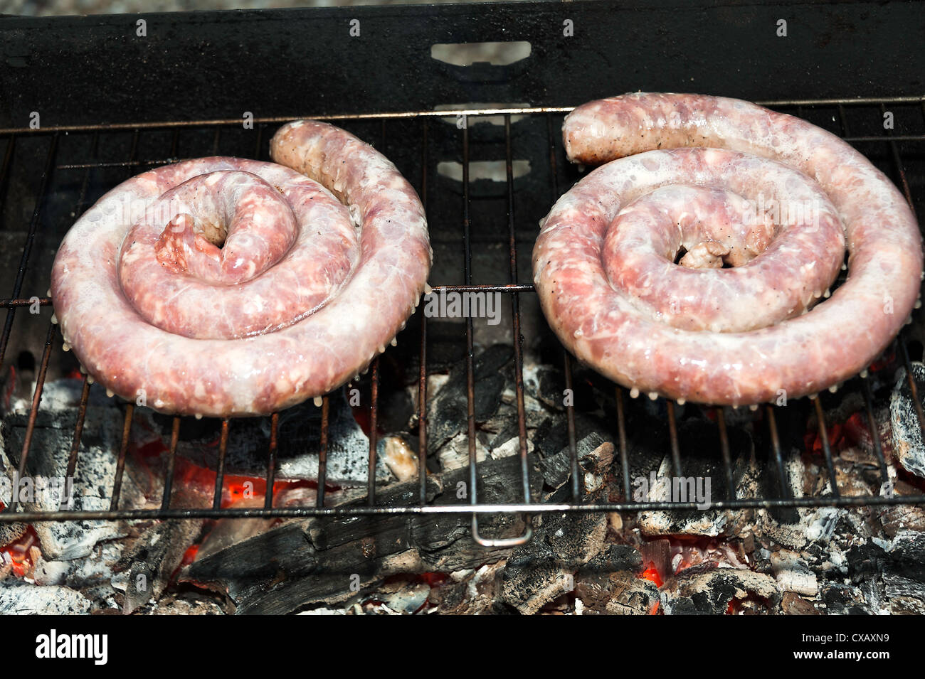 French Pork Sausage Cooking on a Charcoal Barbecue at Laval Midi