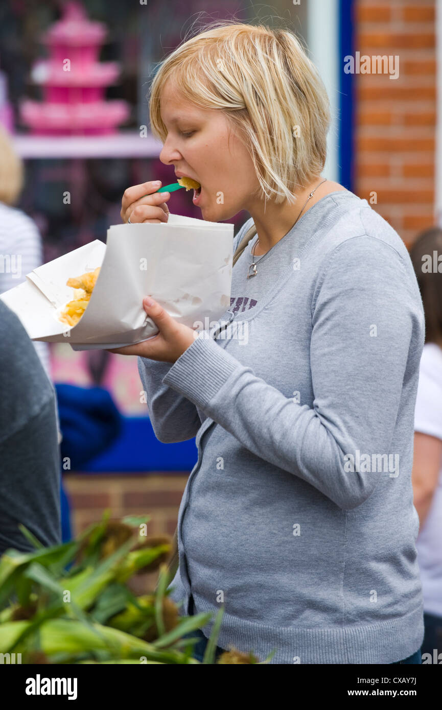 Woman eating fish and chips at Abergavenny Food Festival Stock Photo