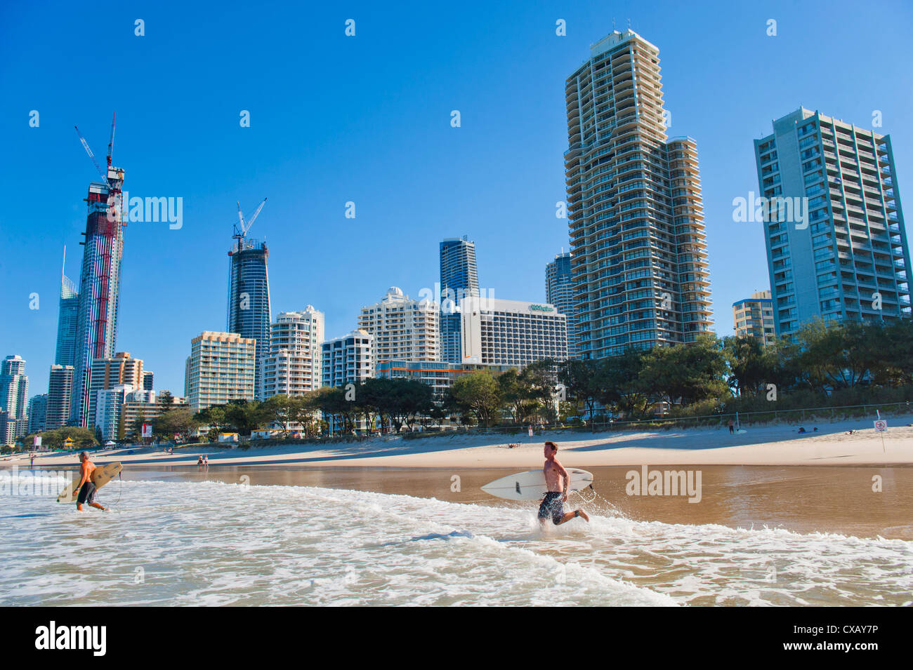 Surfers heading out to surf at Surfers Paradise beach, the Gold Coast