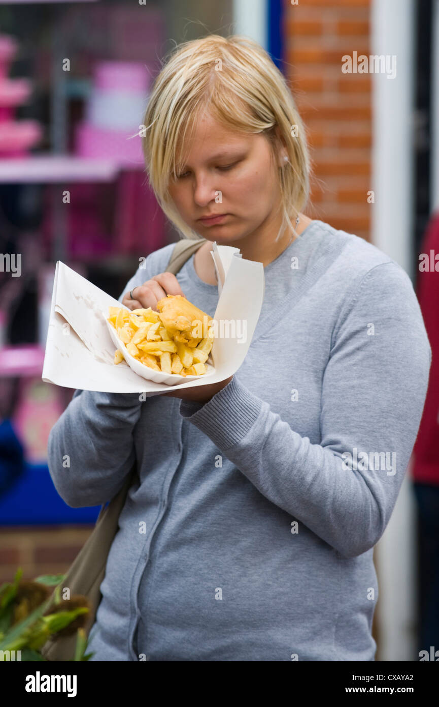Woman eating fish and chips at Abergavenny Food Festival Stock Photo
