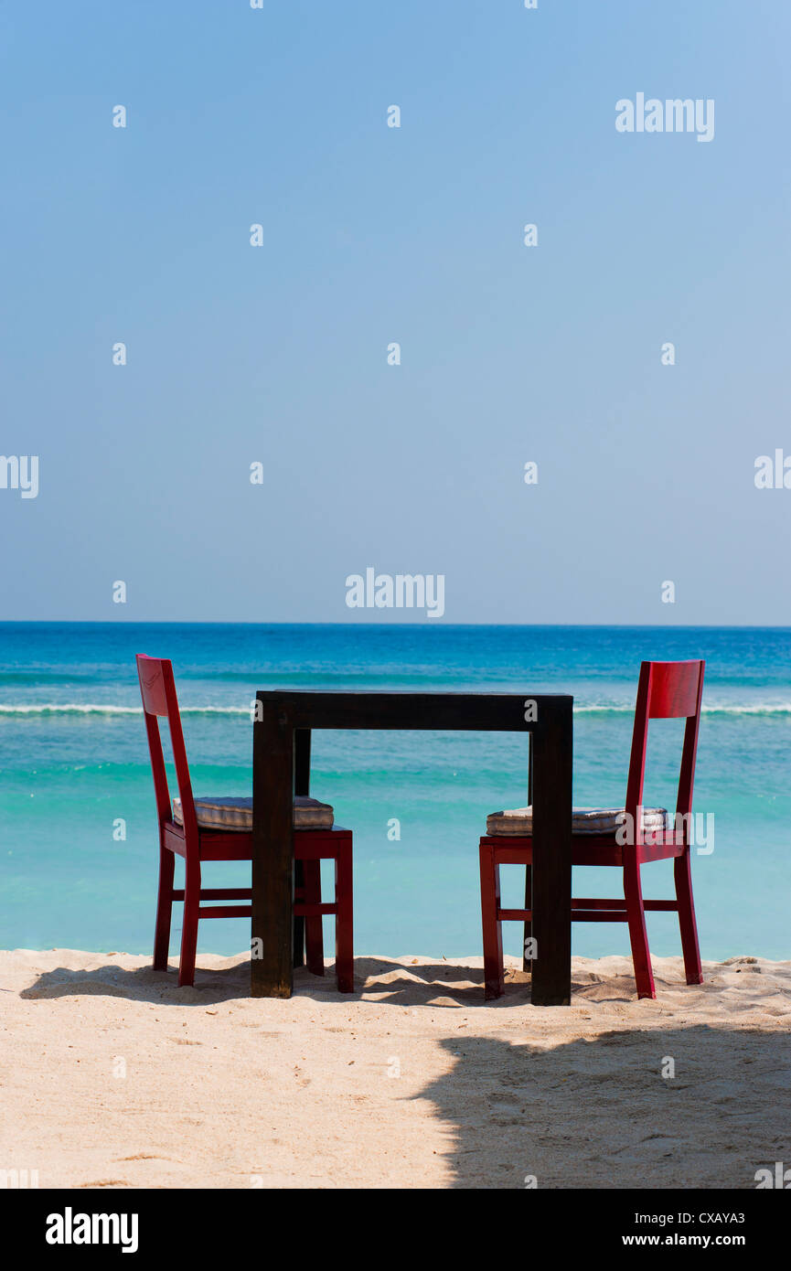 Table and chairs on the beach at a restaurant, Gili Trawangan, Gili Islands, Indonesia, Southeast Asia, Asia Stock Photo