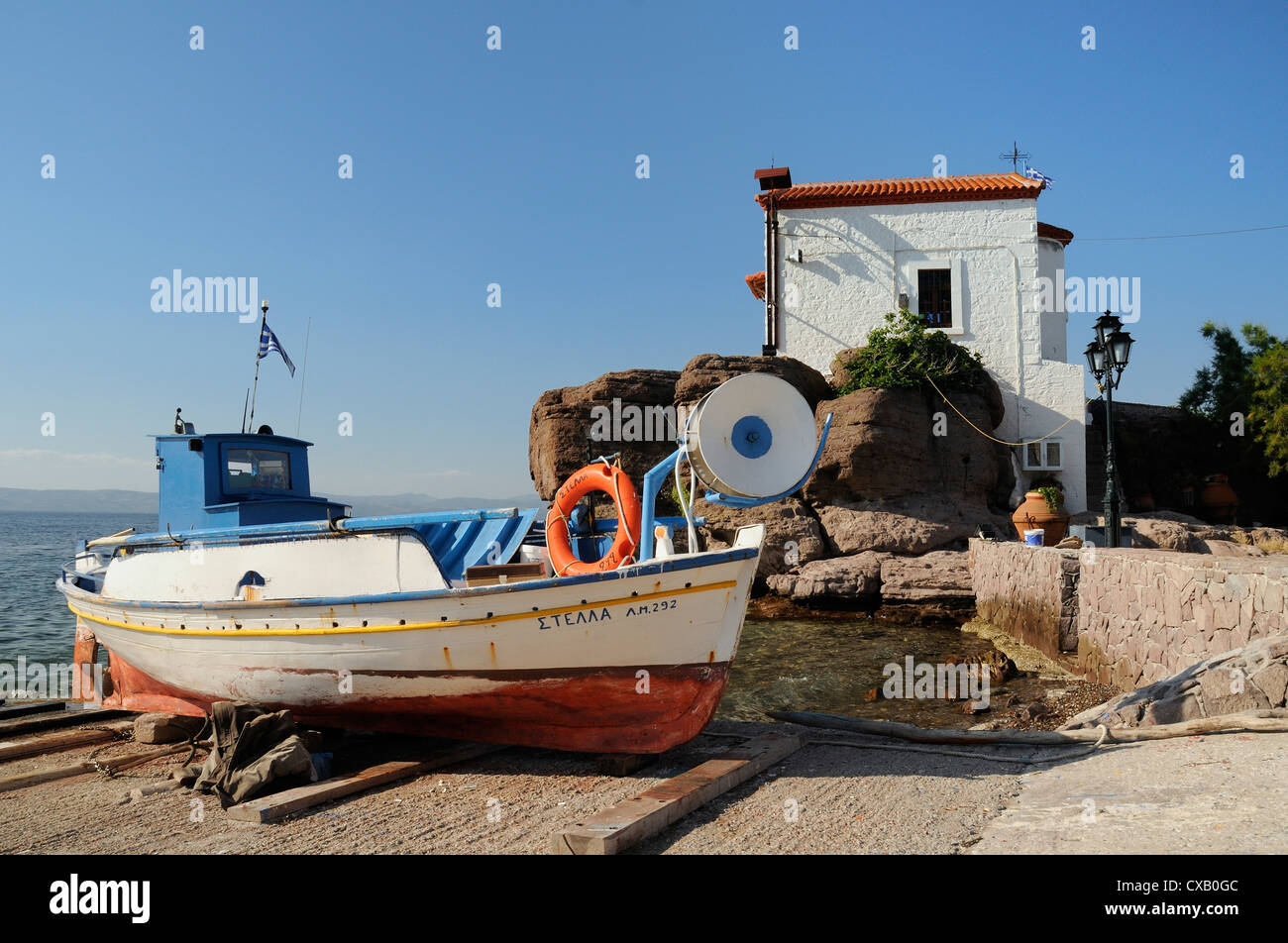 Fishing boat Stella on ramp near small chapel at Skala Sikaminia, Lesbos (Lesvos), Greek Islands, Greece, Europe Stock Photo
