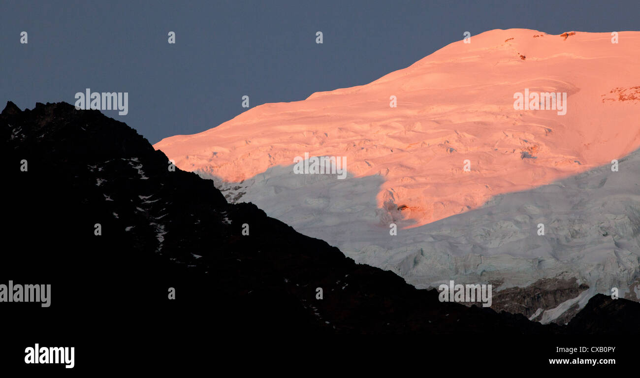 Sunlight hitting a snowcapped mountain along the Langtang Valley, Nepal Stock Photo