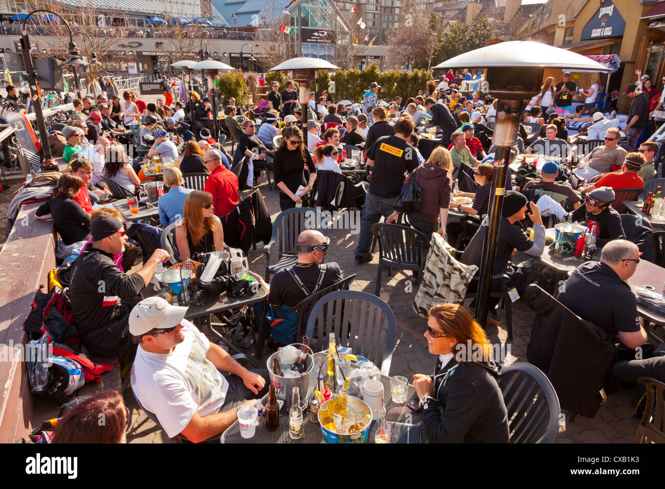 Visitors enjoying apres ski at an outdoor patio, Whistler Ski
