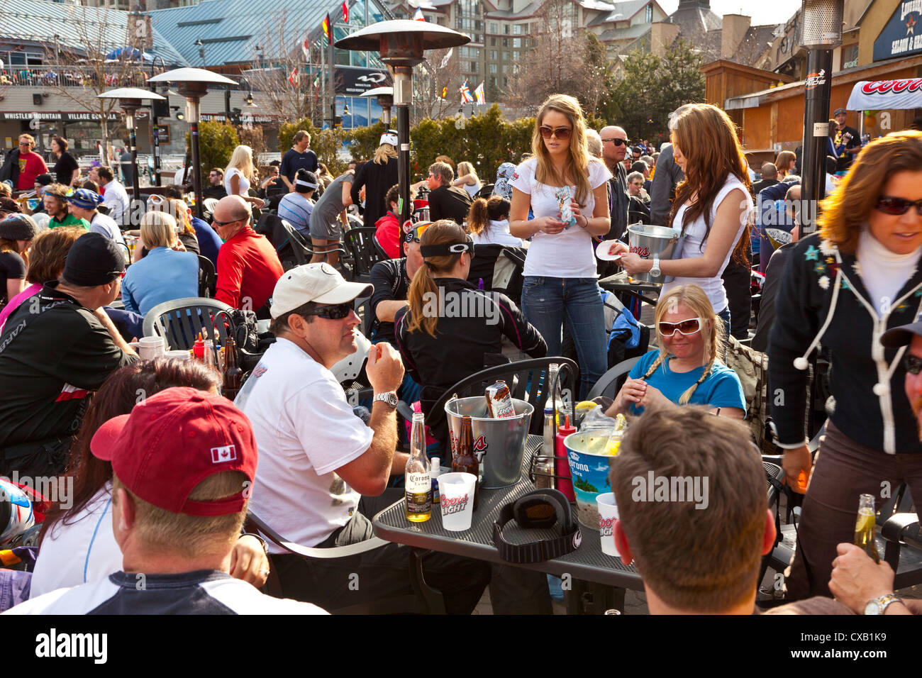 Visitors enjoying apres ski at an outdoor patio, Whistler Ski