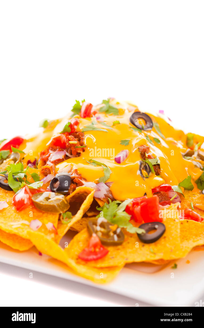 Plate of fresh nachos with a spicy jalapeno cheese sauce Stock Photo