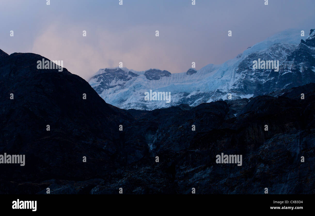 Thick frozen snow on the side of a mountain in the Langtang valley ...