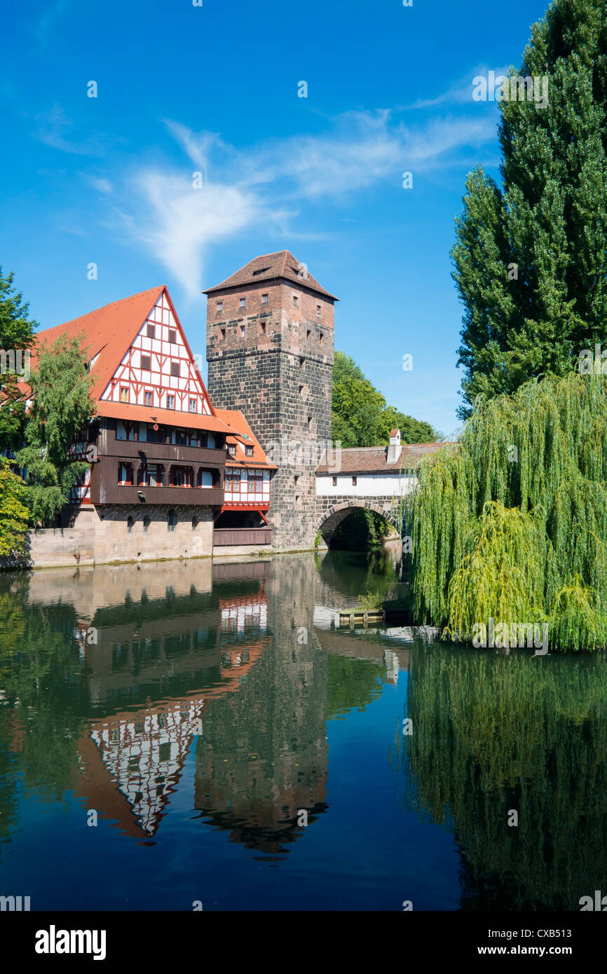 View of historic Wine Vault or Weinstadel, water tower and Hangman's Way or Henkersteg beside Pegnitz River in Nuremberg, German Stock Photo