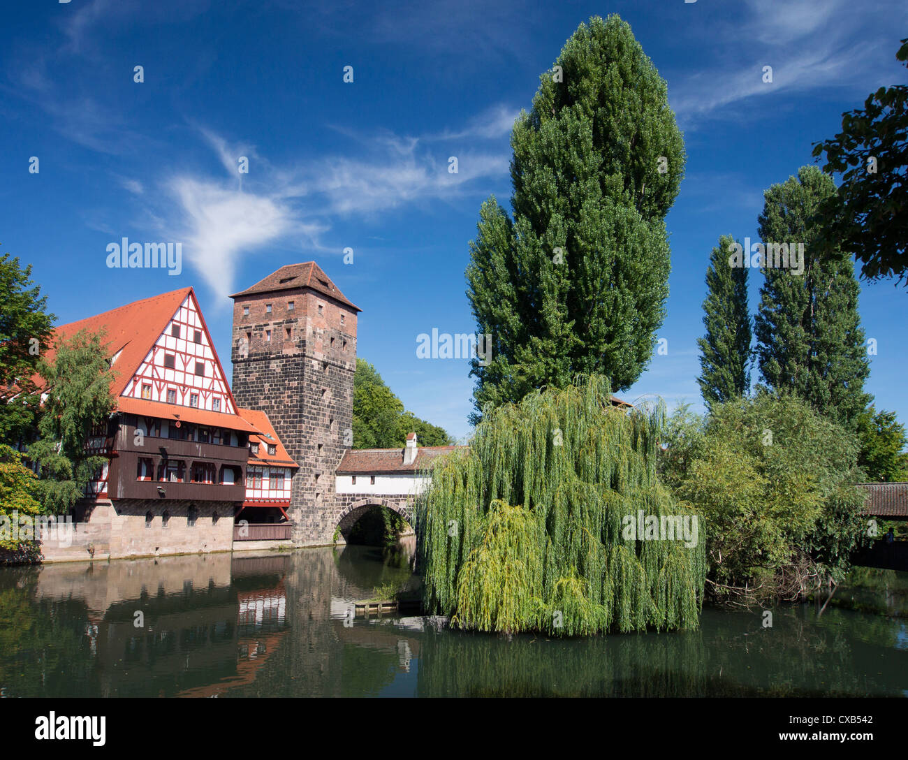 View of historic Wine Vault or Weinstadel, water tower and Hangman's Way or Henkersteg beside Pegnitz River in Nuremberg, German Stock Photo