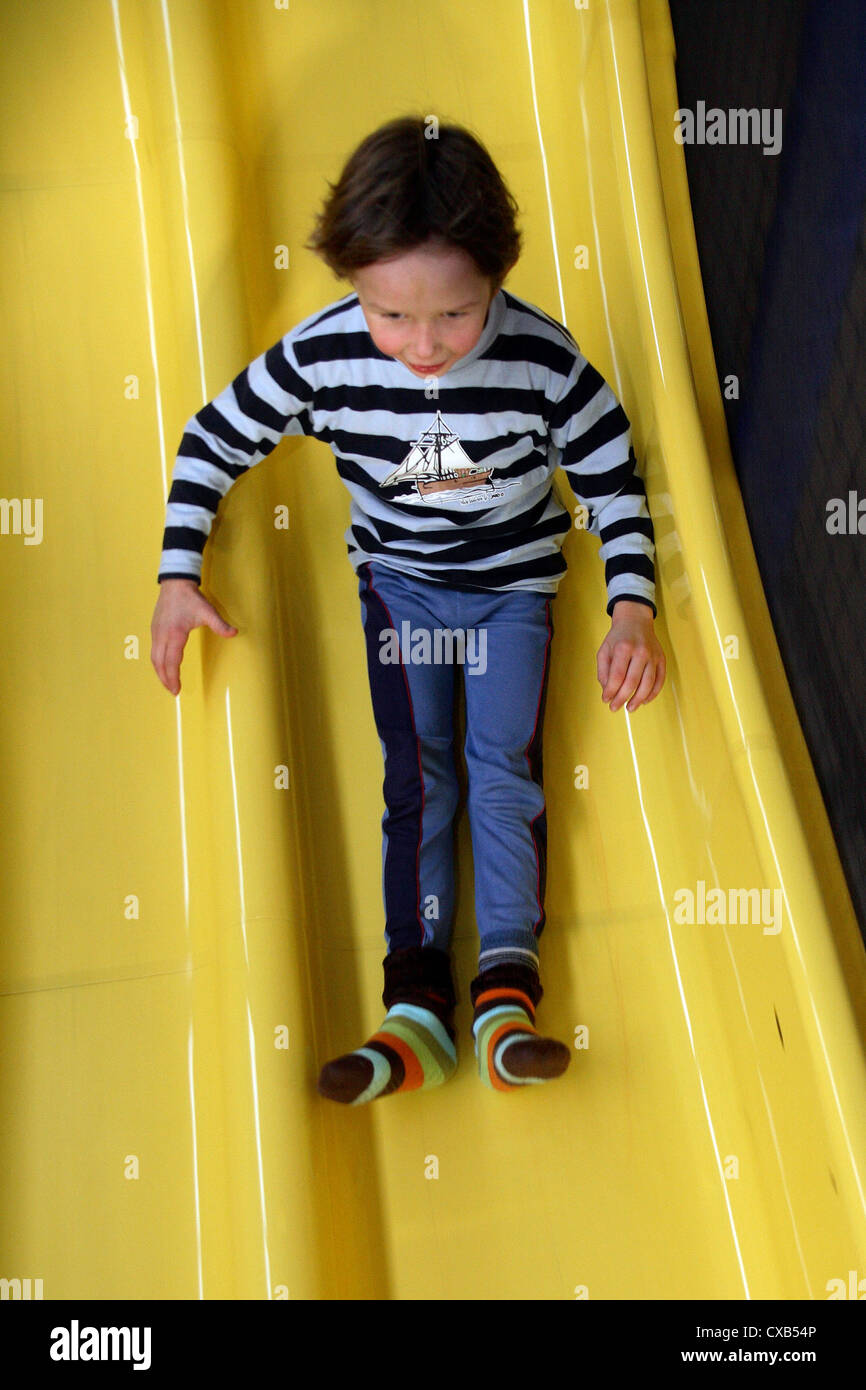 Rostock, child on a slide in the children's area Rostock Stock Photo