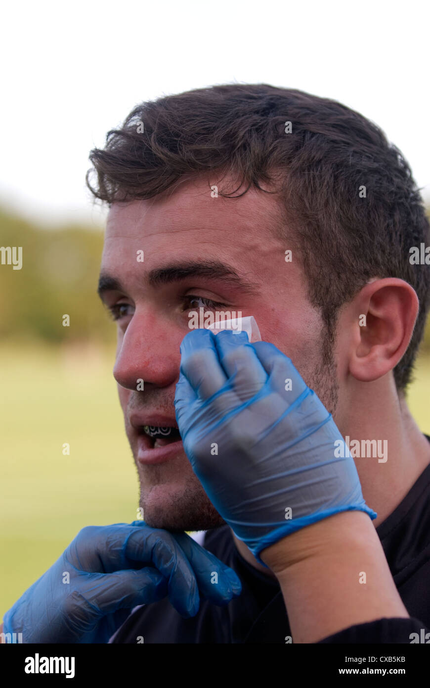 Rugby player receiving medical attention during game, Farnham, Surrey, UK. Stock Photo