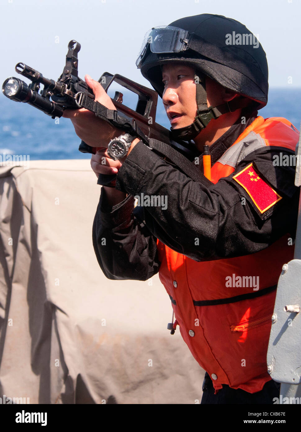Chinese naval special forces team from the Chinese People's Liberation Army frigate Yi Yang participates in a bilateral counter-piracy exercise aboard guided-missile destroyer USS Winston S. Churchill September 17, 2012 in the Gulf of Aden. The focus of the exercise was American and Chinese naval cooperation in detecting, boarding, and searching suspected pirated vessels. Stock Photo