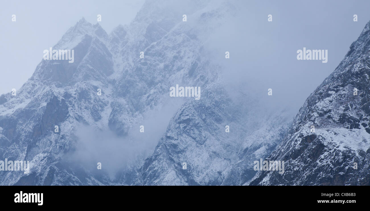 Clouds sweeping over a mountain covered with snow, Langtang valley, Nepal Stock Photo