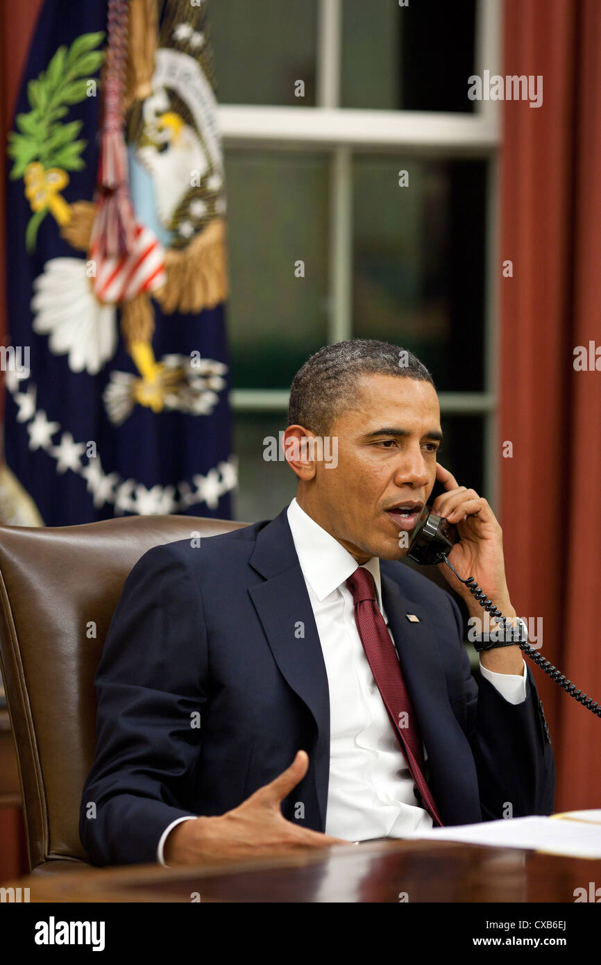 President Barack Obama talks on the phone May 1, 2011 in the Oval Office before making a statement to the media about the mission against Osama bin Laden. The President made a series of calls including to Presidents George W. Bush and Bill Clinton and others to inform them of the successful mission. Stock Photo