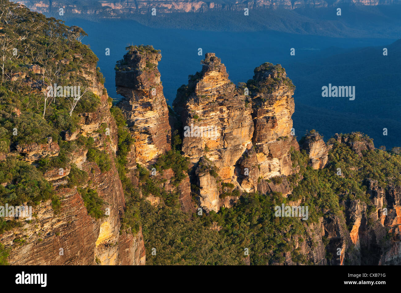 The rock formation of the Three Sisters towering over Jamison Valley. Stock Photo