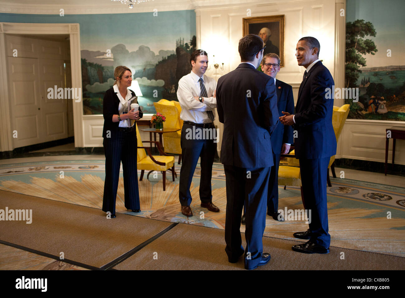 US President Barack Obama talks with staff October 14, 2011 in the Diplomatic Reception Room of the White House as he waits for the arrival of Marine One. Talking with the President, from left, are: Amy Brundage, Assistant Press Secretary; Josh Earnest, Principal Deputy Press Secretary; Brian Deese, National Economic Council Deputy Director; and Press Secretary Jay Carney. Stock Photo