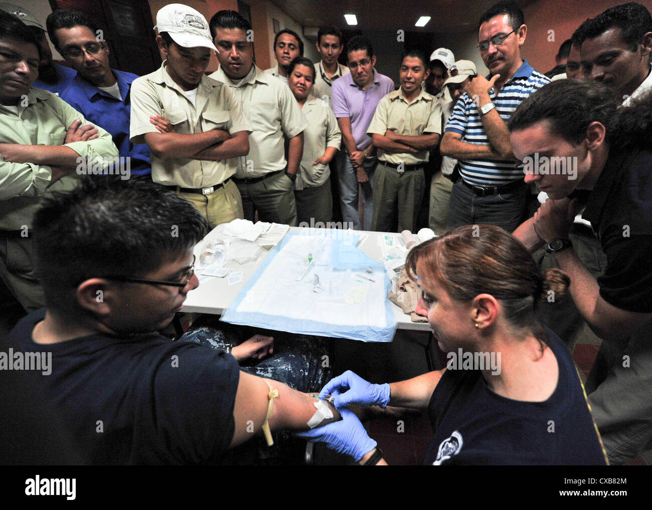 Lt. Cmdr. Rebecca Pate, from San Diego, demonstrate how to give a patient an intravenous therapy during a Continuing Promise 2011 trauma care subject matter expert exchange at Universidad Modular Abierta. Continuing Promise is a five-month humanitarian assistance mission to the Caribbean, Central and South America. Stock Photo