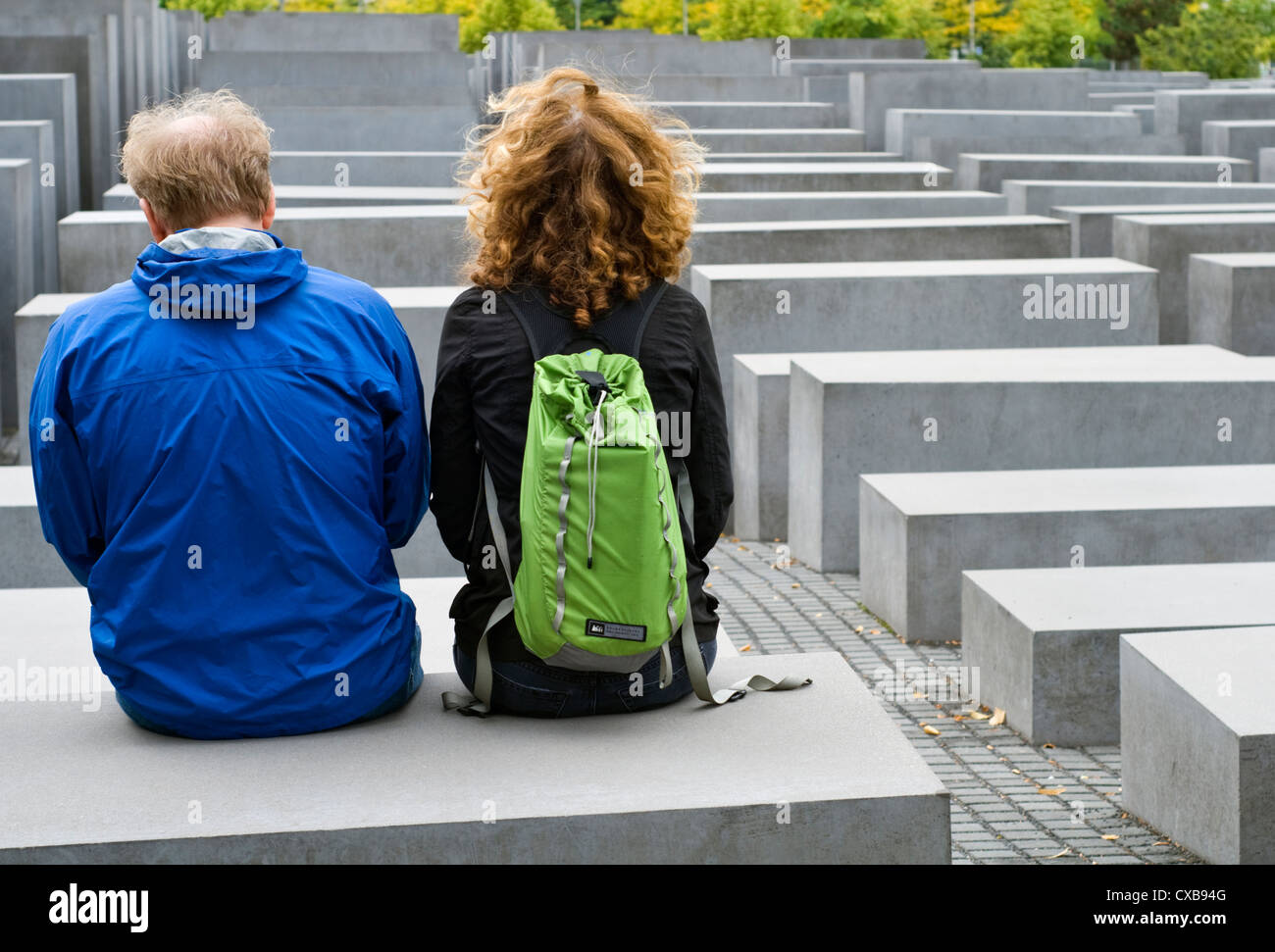 Two tourists sitting on one of the concrete blocks that make up the