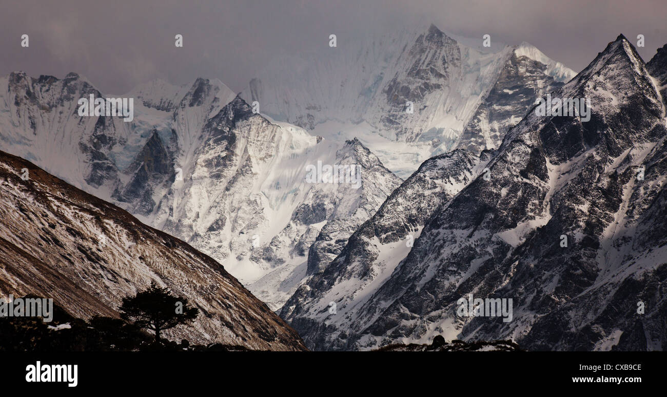 Warm pink light surrounding a snowcapped mountain at sunset, Langtang valley, Nepal Stock Photo