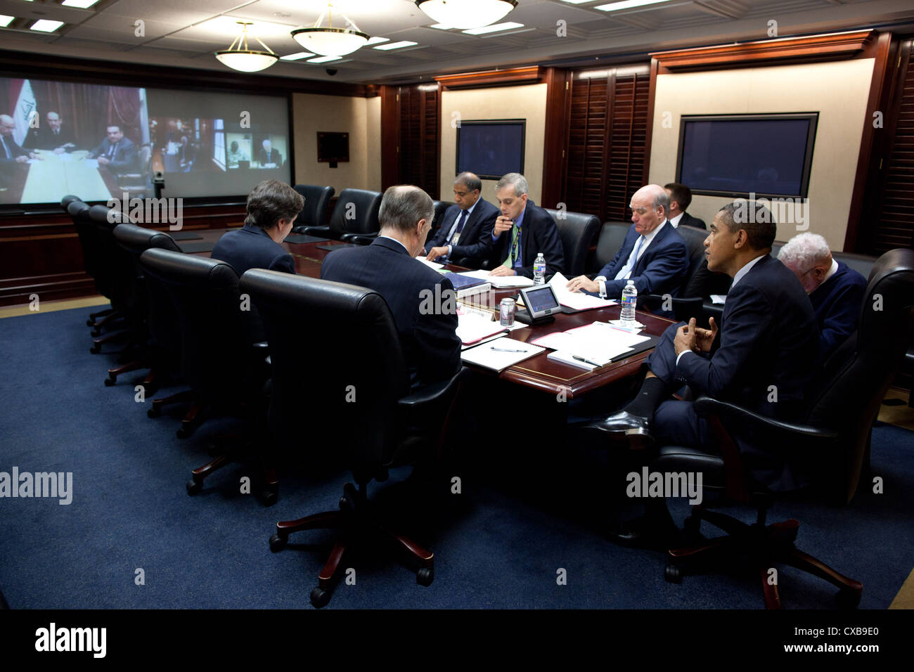 US President Barack Obama talks with Iraqi Prime Minister Nouri al-Maliki during a secure video teleconference October 21, 2011 in the Situation Room of the White House. Seated at the table, from left, are: Tony Blinken, National Security Advisor to the Vice President ; National Security Advisor Tom Donilon; Puneet Talwar, Senior Director for Iraq, Iran and the Gulf States; Deputy National Security Advisor Denis McDonough; and Chief of Staff Bill Daley. Pictured on screen, from left, are: Prime Minister al-Maliki, along with two aides; Vice President Joe Biden; and General Lloyd Austin, Comman Stock Photo