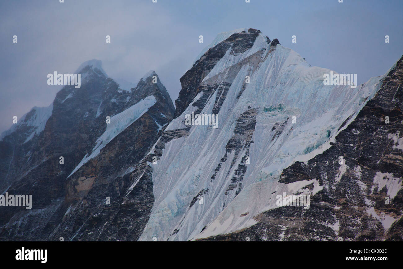 Ice sheets on the side of a snowcapped mountain along the Langtang Valley, Nepal Stock Photo
