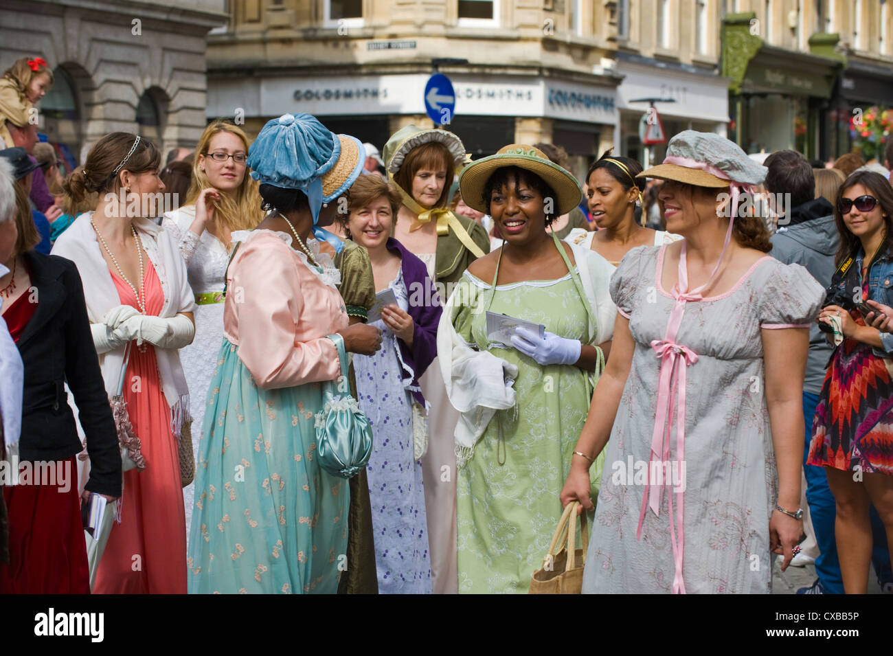 Ladies in Regency costume promenade through Bath city centre during the 2012 Jane Austen Festival Stock Photo