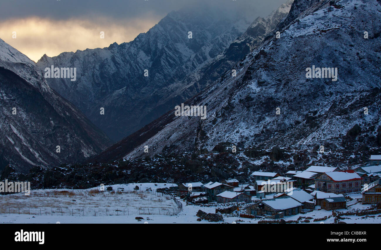 Village of Kyanjin Gompa with snowcapped mountains along the Langtang Valley in the distance, Nepal Stock Photo