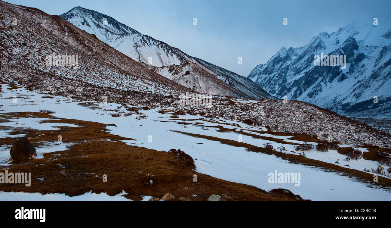 Remote scrubland and mountains covered in snow along the Langtang ...