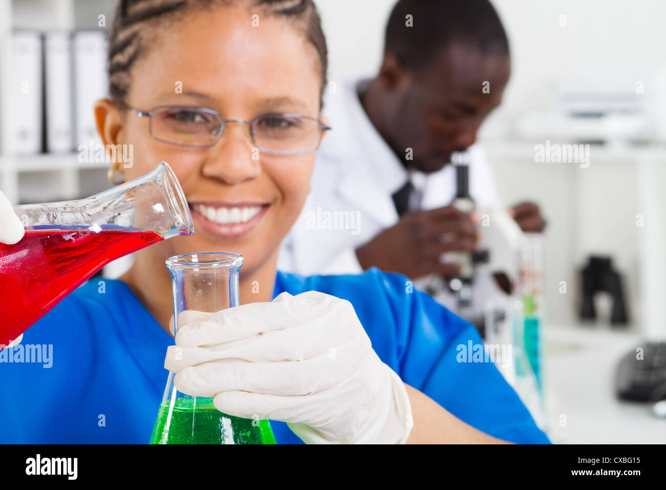 african american female scientist doing experiment in lab, background