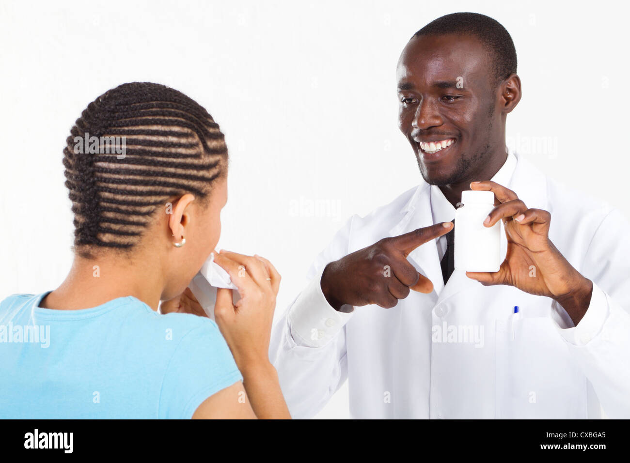 african american pharmacist explain how to take the prescription medicine to sick patient Stock Photo