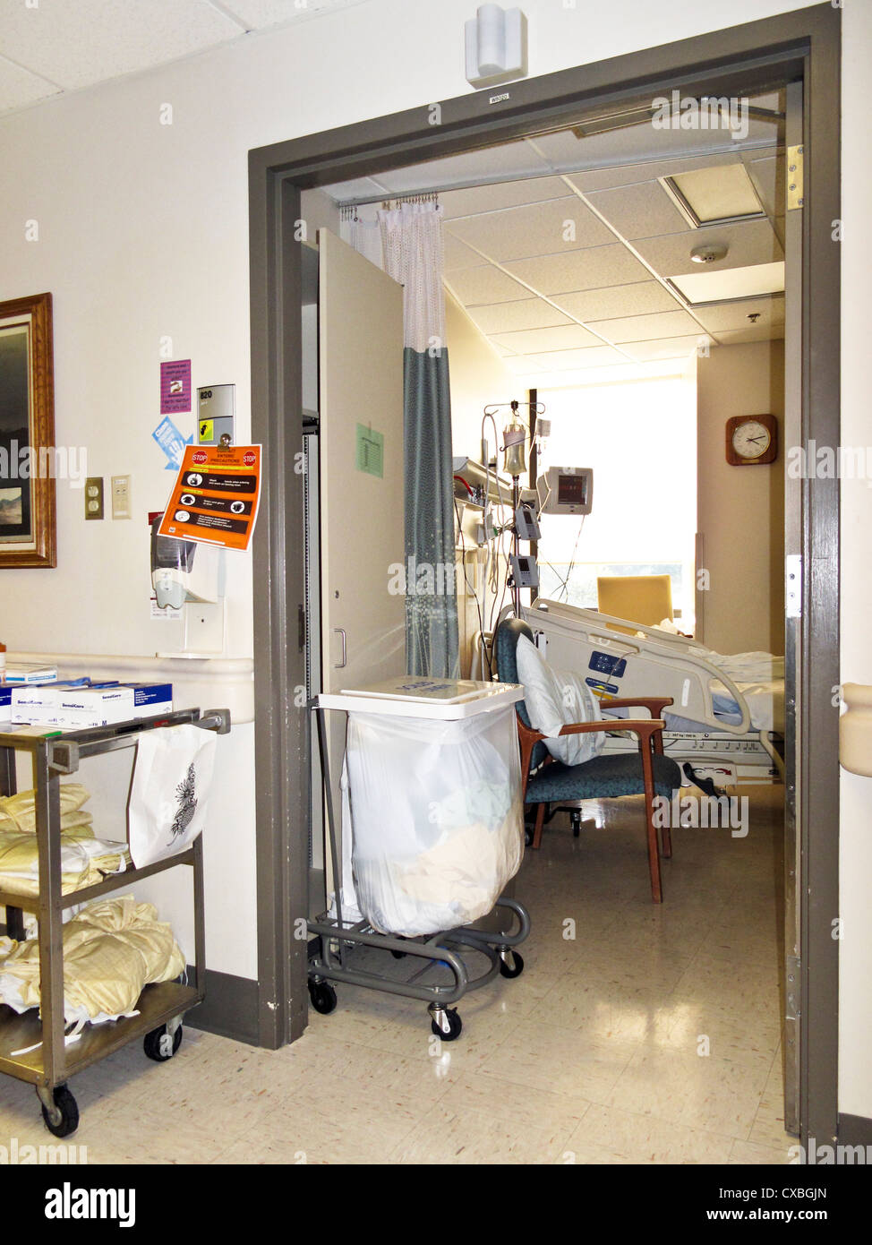 view from corridor into patient room & furnishings with hospital bed