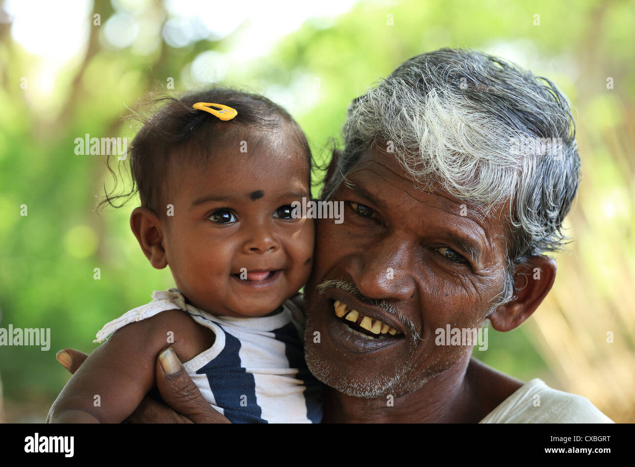 Rural old man with little girl Andhra Pradesh South India Stock Photo