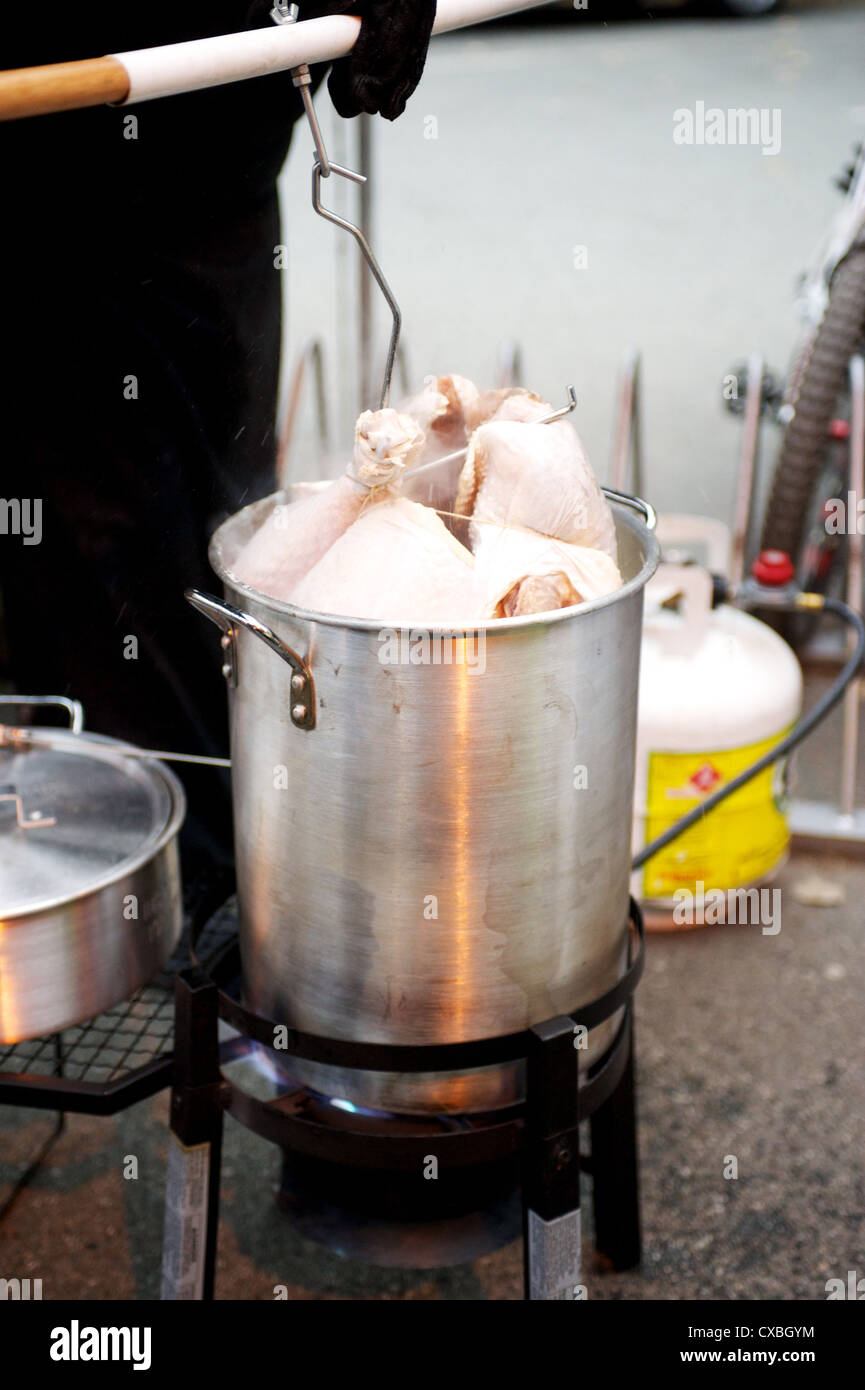 A whole turkey being deep fried in an outdoor kitchen Stock Photo Alamy