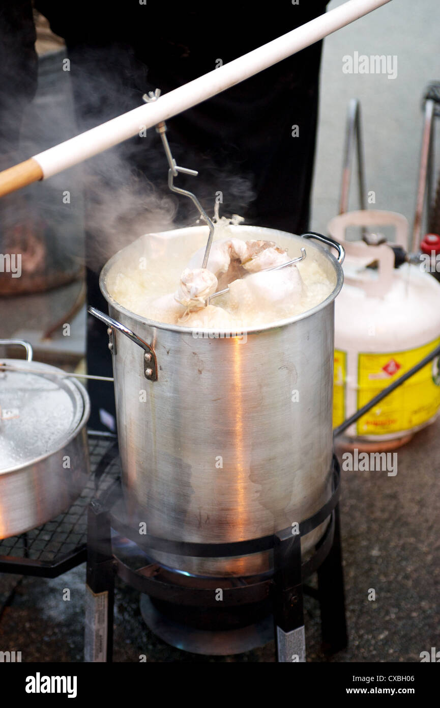 A whole turkey being deep fried in an outdoor kitchen Stock Photo Alamy