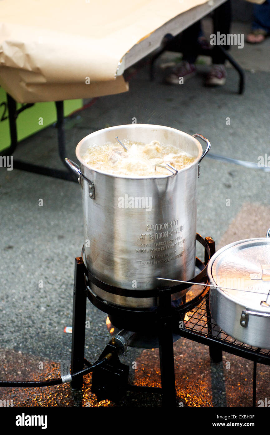 A whole turkey being deep fried in an outdoor kitchen Stock Photo Alamy