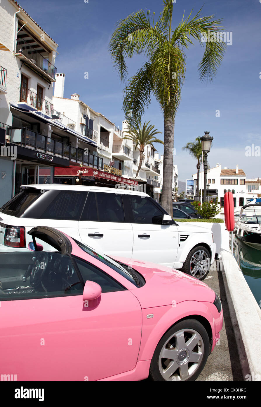 Sports cars parked next to yachts in the Luxury marina of Puerto banus,  Marbella, Spain Stock Photo - Alamy