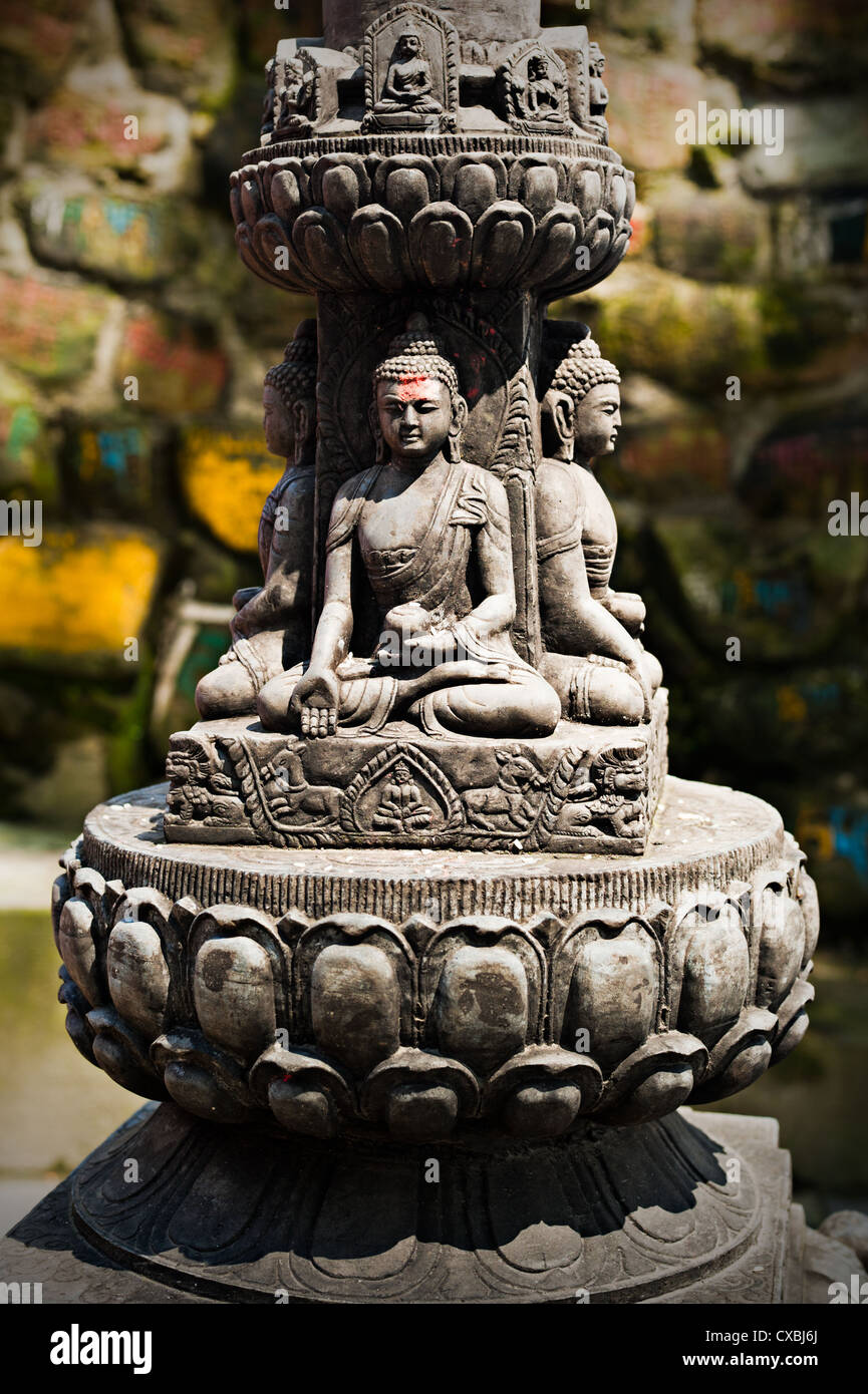 Buddha sculpture in Tibetan Monastery over prayer stones background
