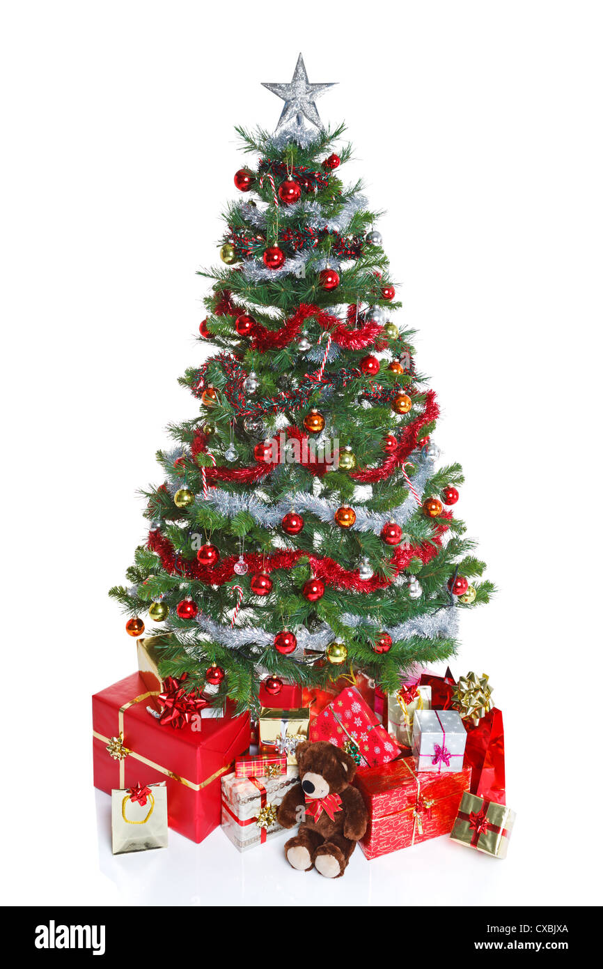 Decorated Christmas tree with baubles and tinsel surrounded by gift wrapped presents and a teddy bear Stock Photo