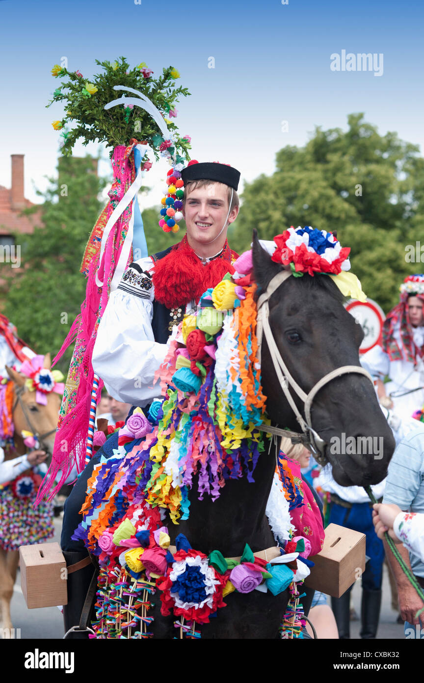 Man riding horse and wearing folk dress during festival Ride of the Kings, Vlcnov, Zlinsko, Czech Republic, Europe Stock Photo