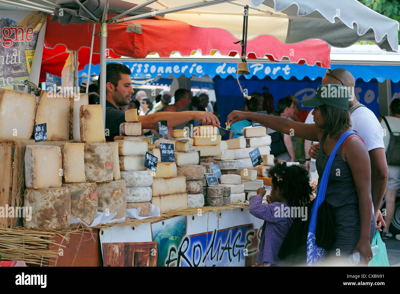 French market cheese stall with people trying samples Stock Photo