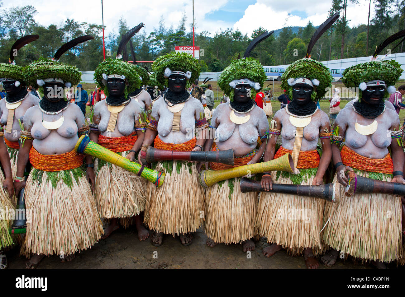 Colourfully dressed and face painted local ladies celebrating the traditional Sing Sing in the Highlands of Papua New Guinea Stock Photo
