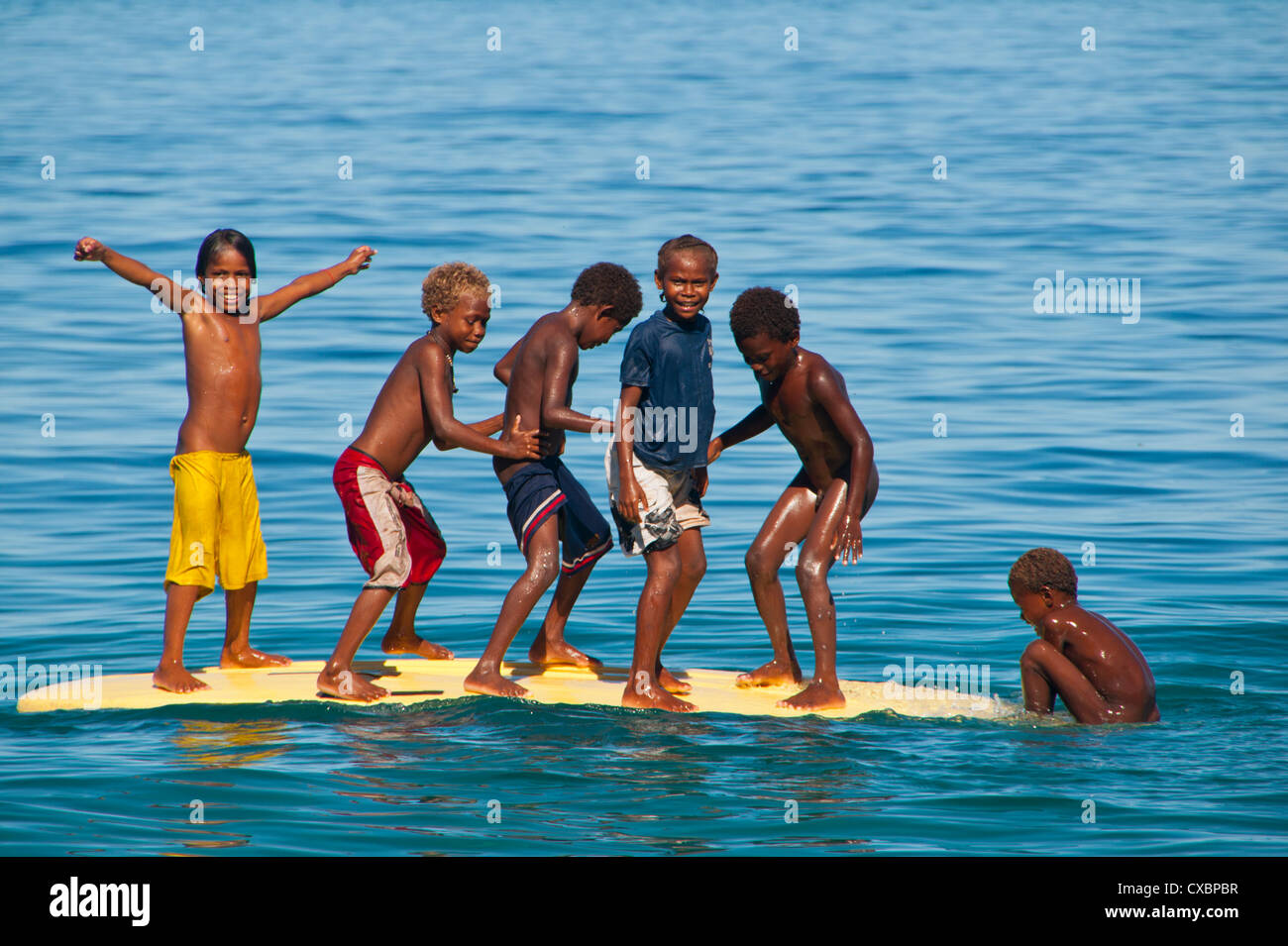 Happy children playing on the beach of Savo island, Solomon Islands, Pacific Stock Photo