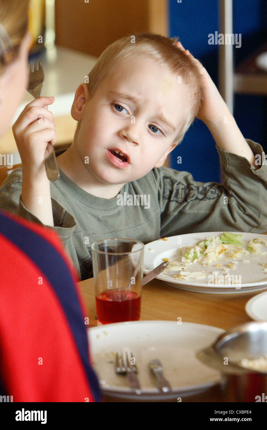 Berlin, boy sitting in front of his plate Stock Photo