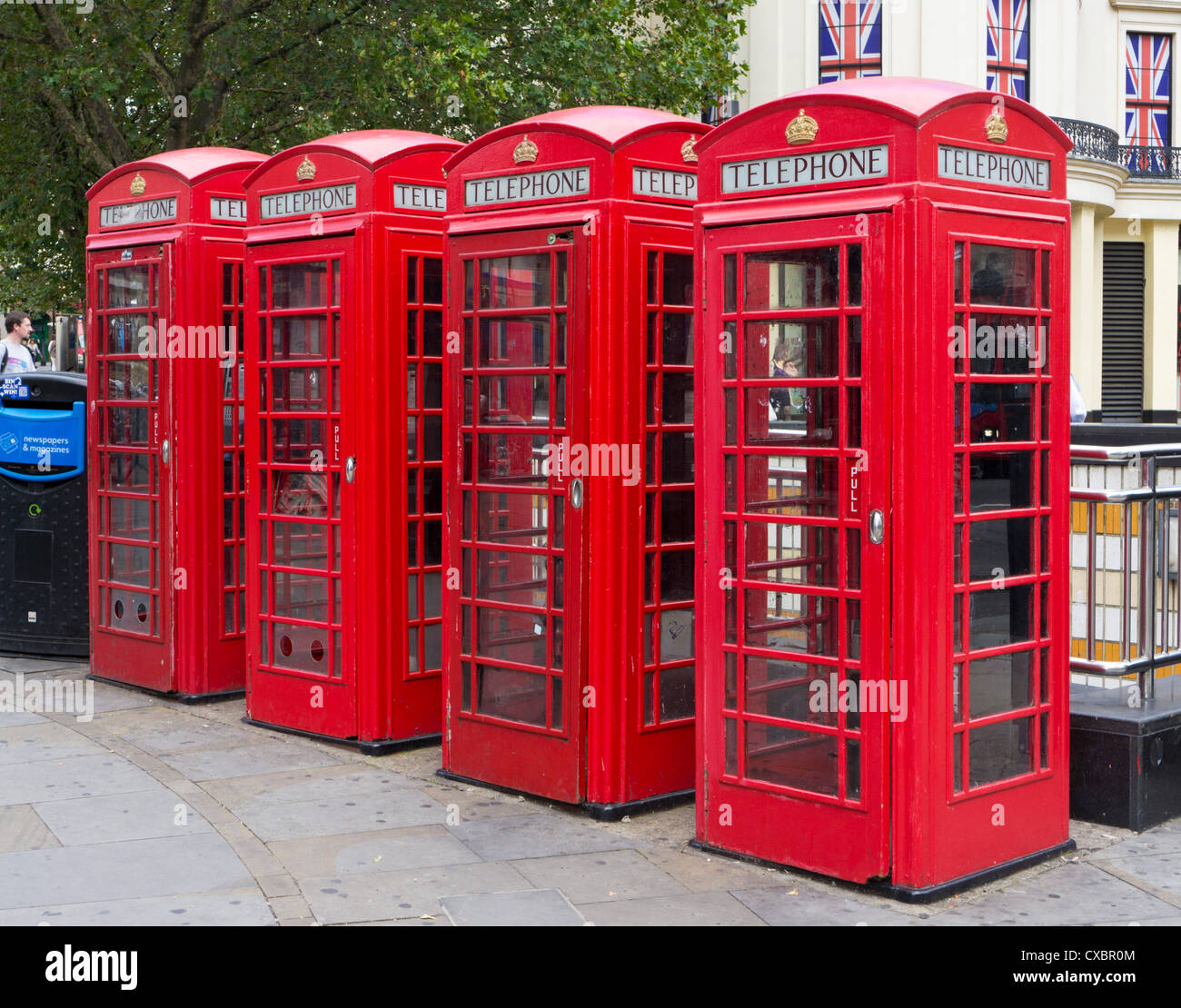 Row of four traditional red telephones boxes in Central London England UK GB EU Europe Stock Photo