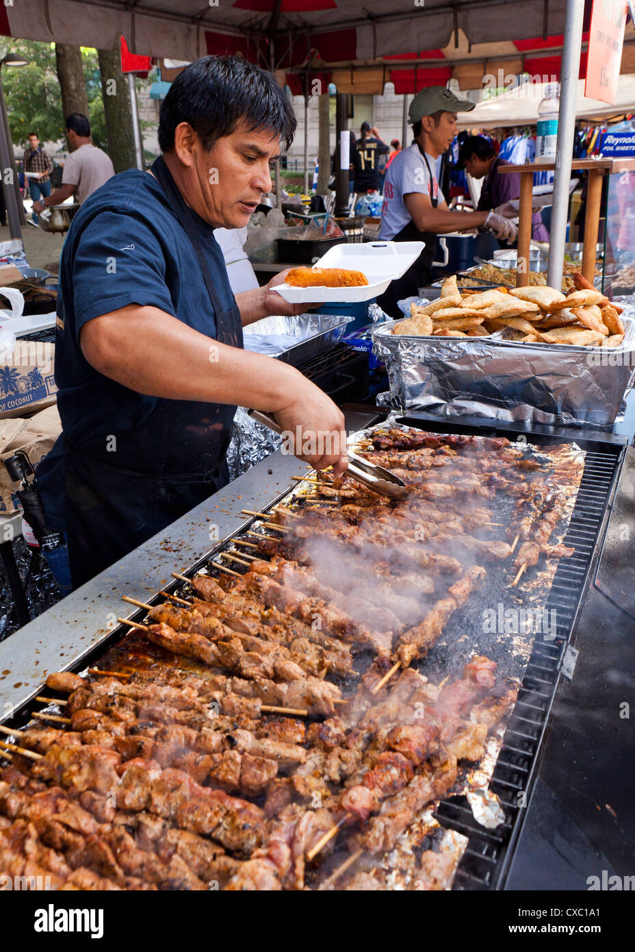 Man grilling barbecue chicken skewers USA Stock Photo Alamy