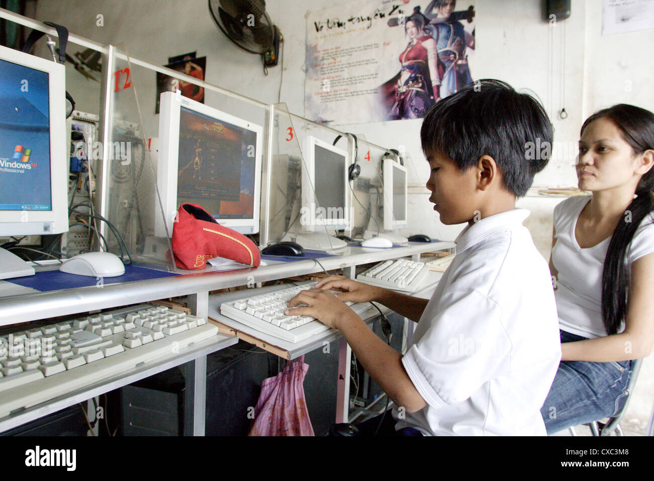 Vietnam, boy surfing and playing in an internet cafe Stock Photo