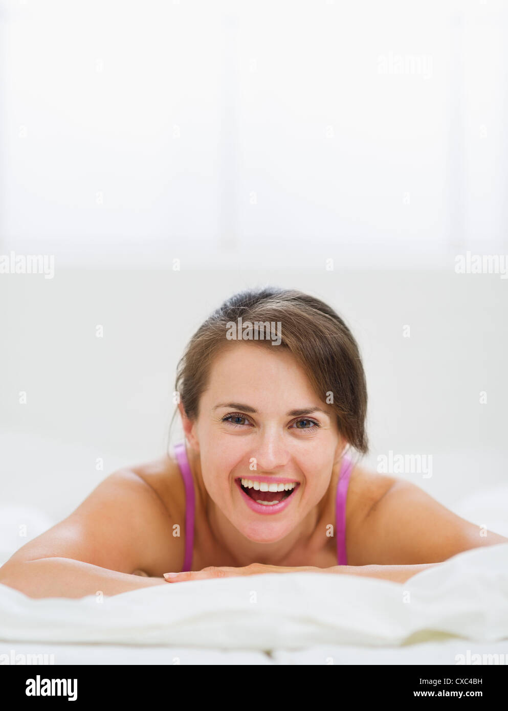 Portrait of happy girl laying on bed Stock Photo Alamy