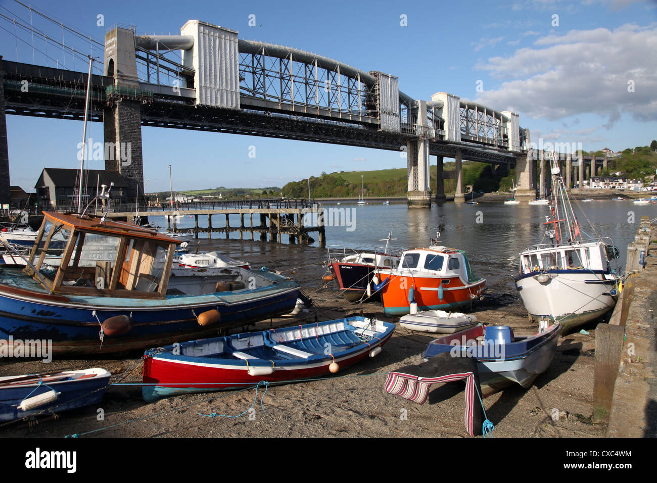 Boats on the beach at Saltash on the Cornish side of Brunel's bridge between Devon and Cornwall over the Tamar River, Cornwall Stock Photo