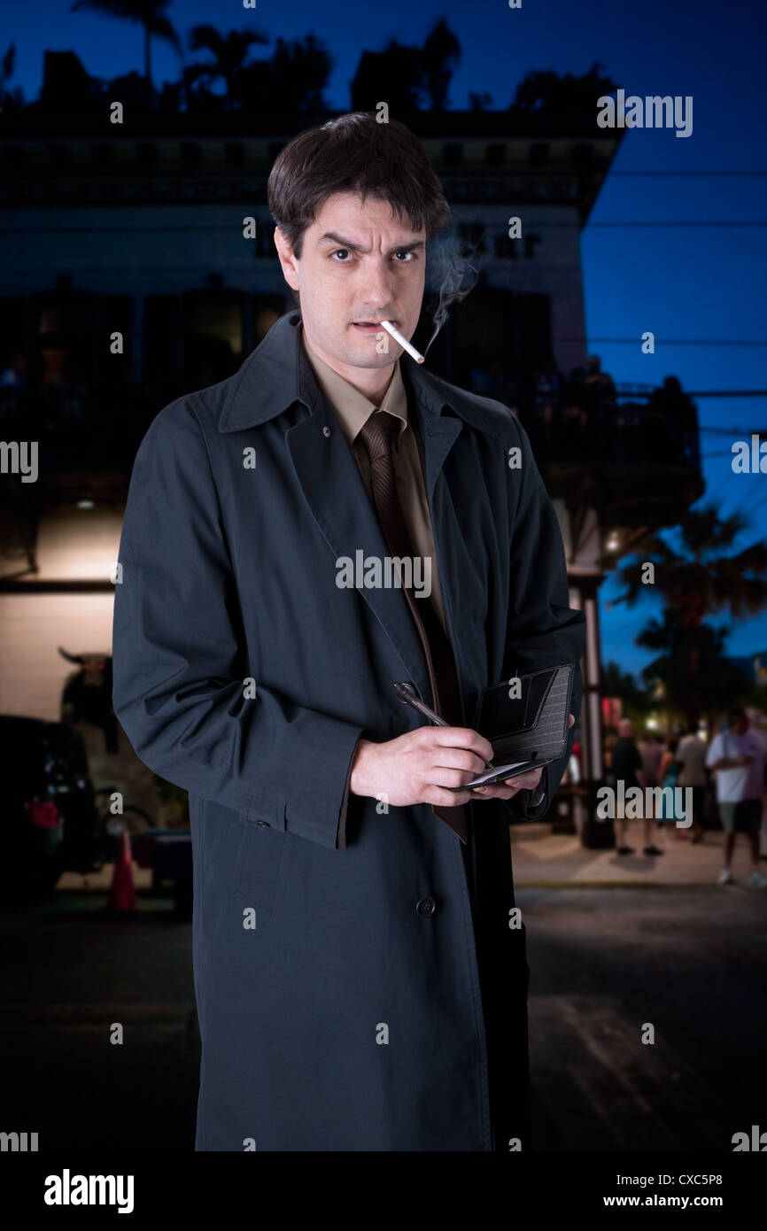 Actor John Scamardella portrays a serious man in a trench coat, on the streets of Key West. Stock Photo
